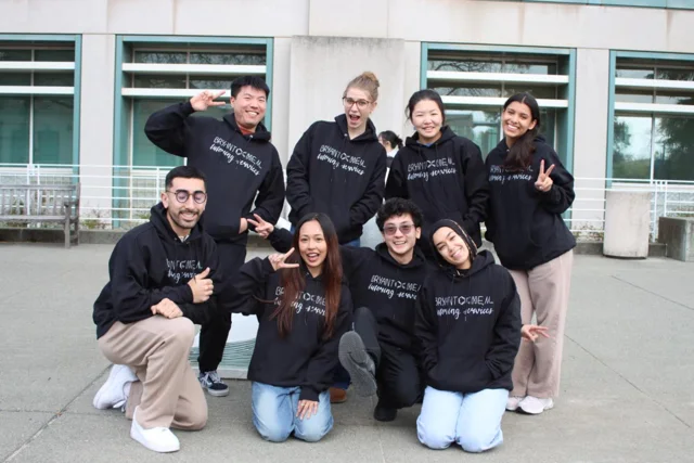 BryantOchem students smiling together in matching hoodies on campus.